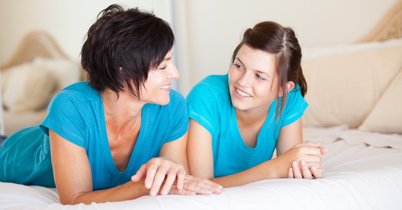 mom talking to teen daughter smiling