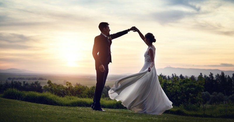 wedding couple dancing outside at sunset