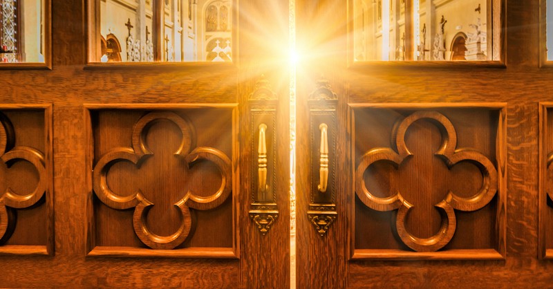 church doors with bright light shining through window