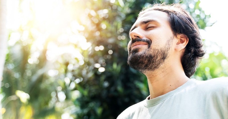 man outside nature eyes closed smiling happy content, fearfully and wonderfully made