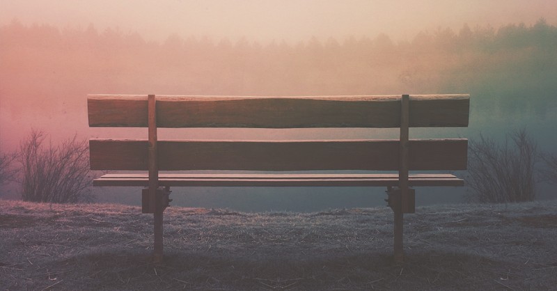 Peaceful bench scene in nature with soft light; practice patience in the process. 