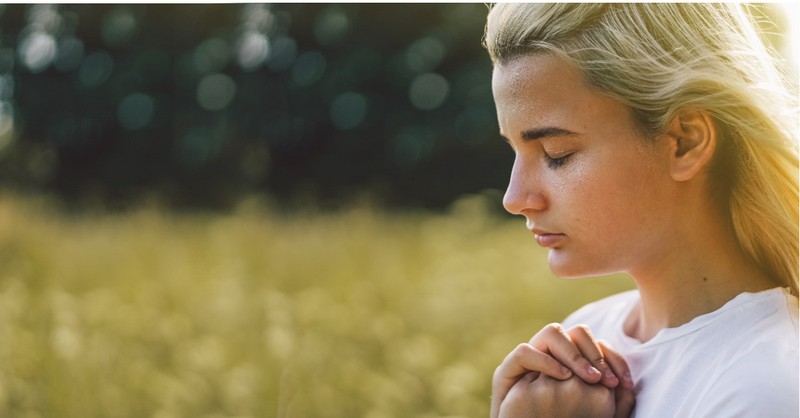 a woman praying outside