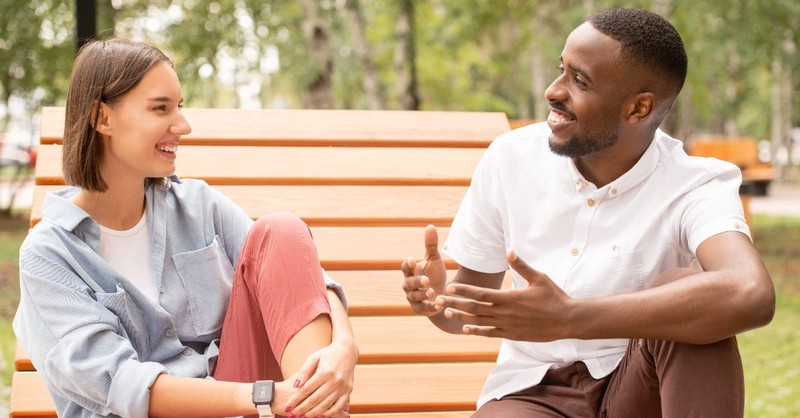 A man and woman talking in the park