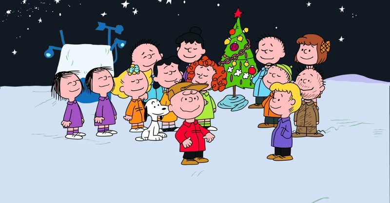 The Peanuts gang gathers around the tree at the end of A Charlie Brown Christmas