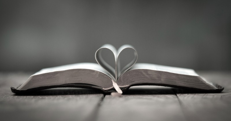 open Bible with pages curved into shape of a heart
