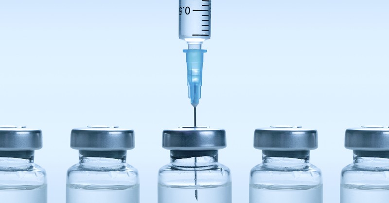 vaccine vials against blue background