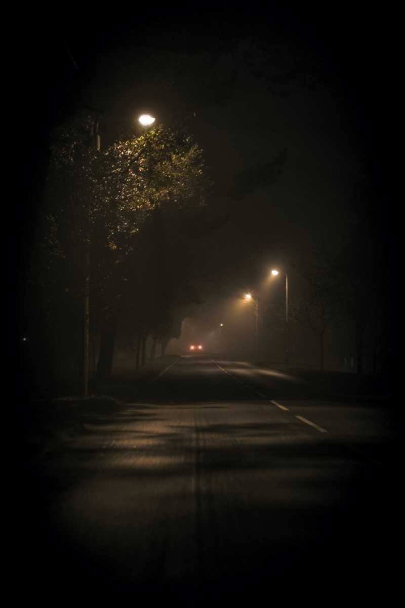 Dark street turned on street lamp, Christian suspense authors christian fiction authors