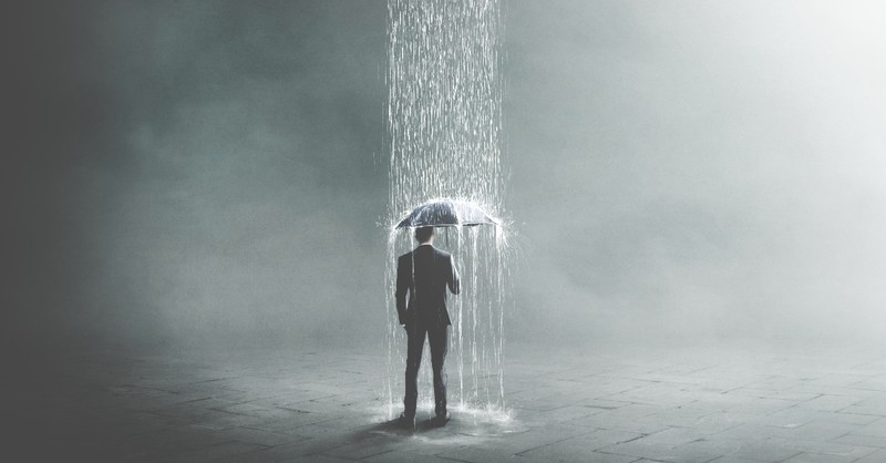 Man standing under a tunnel of rain