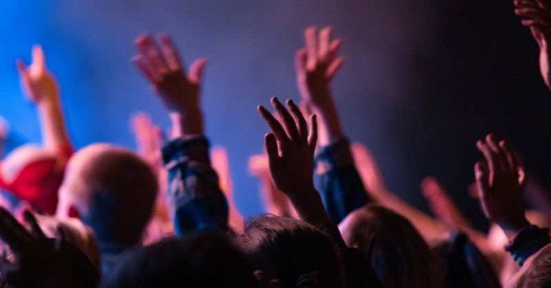 Hands in a crowd raised in prayer