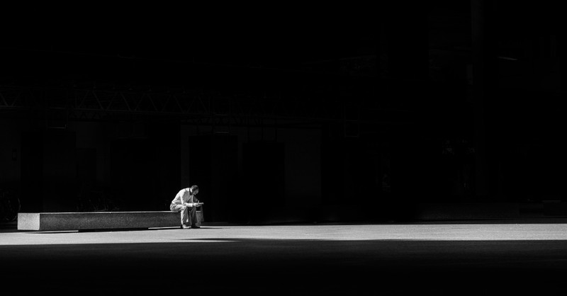Man sitting alone in the dark to illustrate absalom in the bible