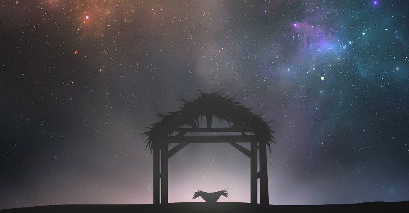 Silhouette of a manger and stable against a starry sky