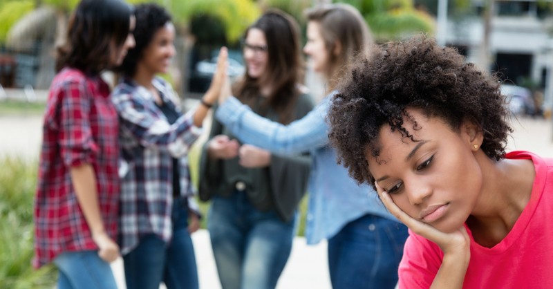 Sad woman excluded from group