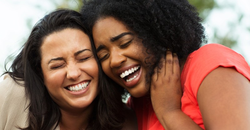 two women best friends laughing together