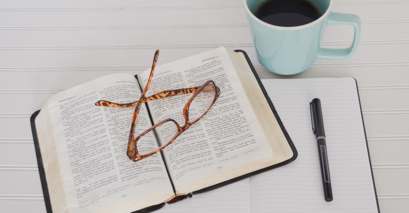 Open Bible with glasses and coffee