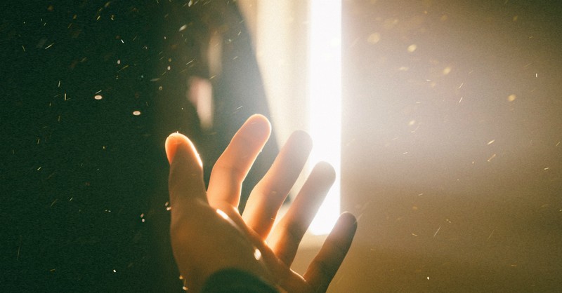 hand reaching toward light