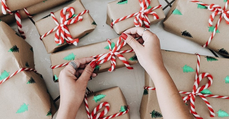 small boxes wrapped in brown paper with Christmas trees and candy cane ribbons