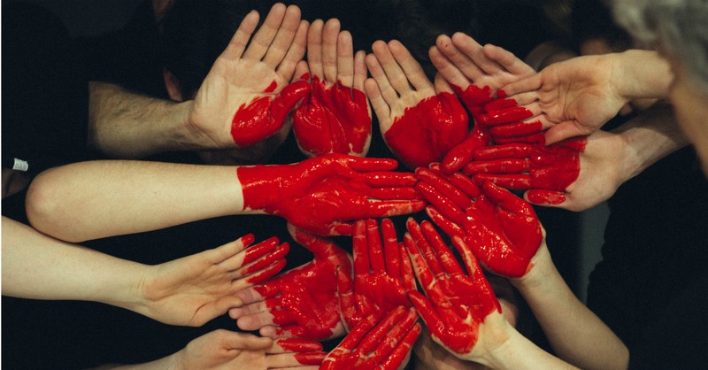 hands together with heart painted