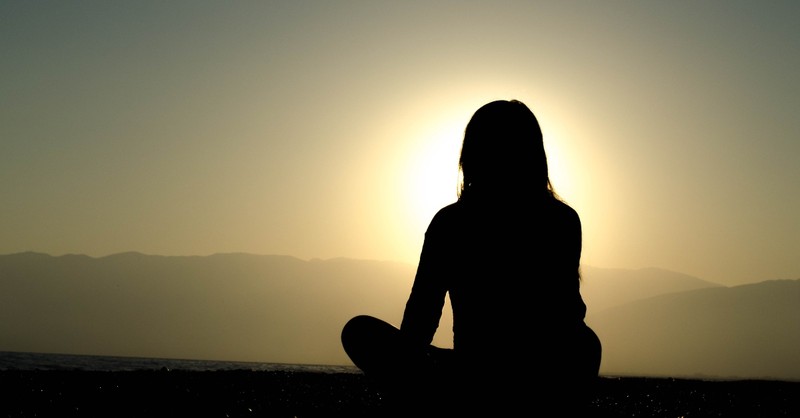 woman looking at sunset, peaceful