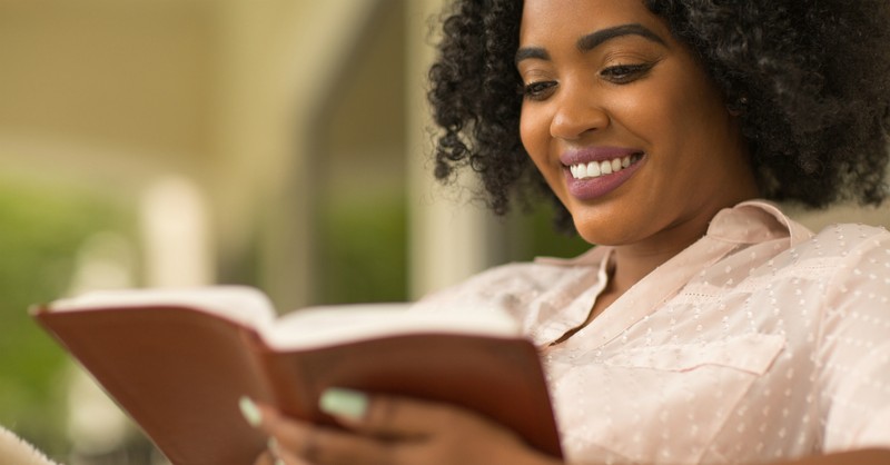 happy woman reading the Bible