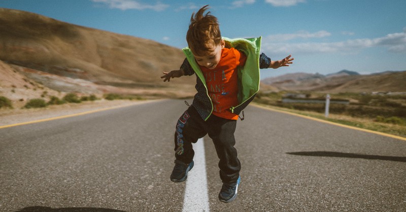 Young boy jumping and playing