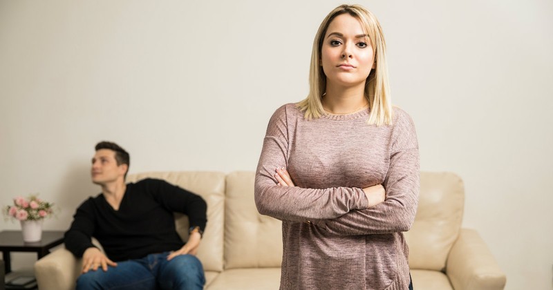 woman standing apart from man looking proud