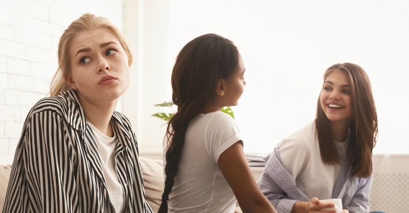 sad woman looking left out of a group