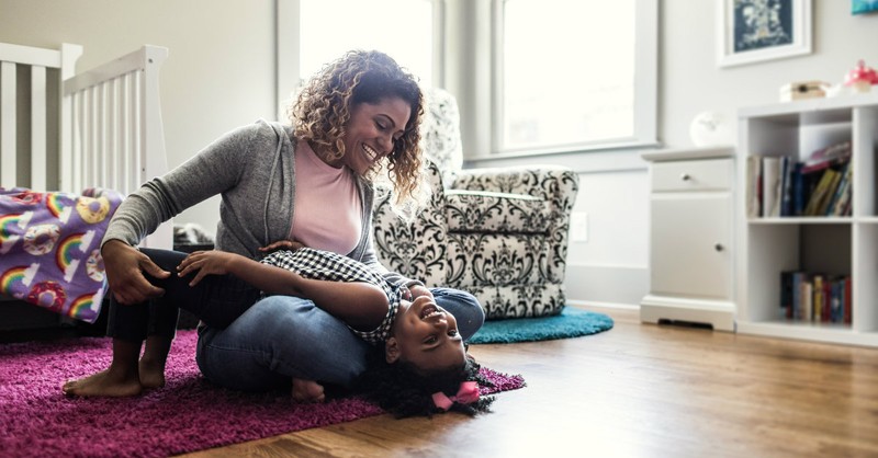 mom playing with daughter in room