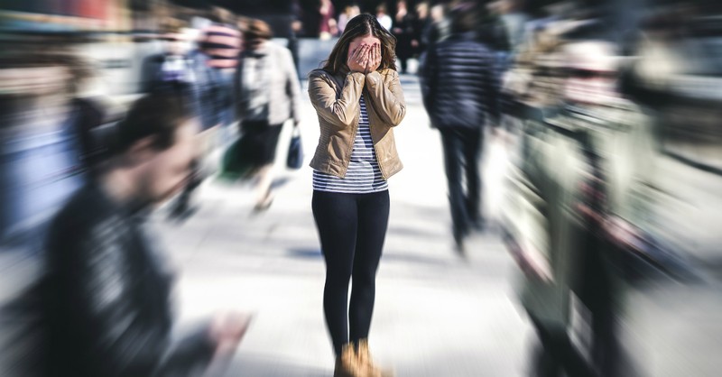 woman standing in busy street, afraid, fear hinders our witness