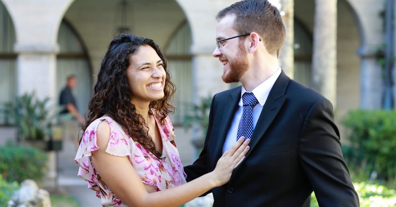 couple laughing outside church, define the relationship