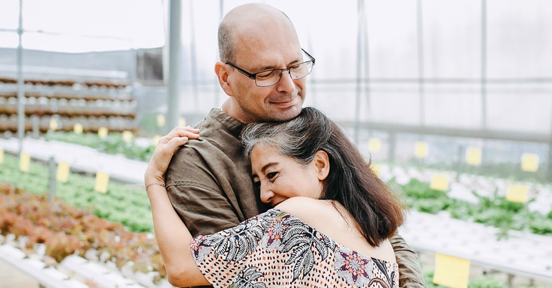 happy husband and wife hugging, prayer for spouse's health