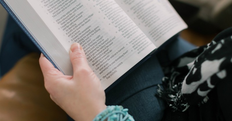 Woman with a Bible open in her lap