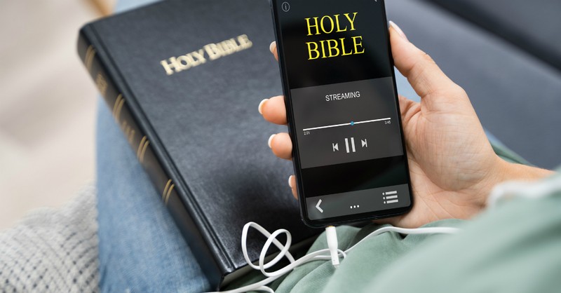 Person listening to the Bible on their phone