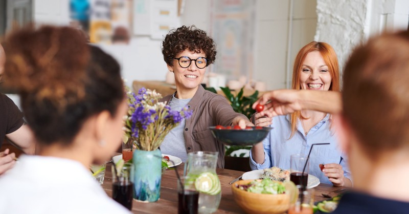 friends at table serving each other