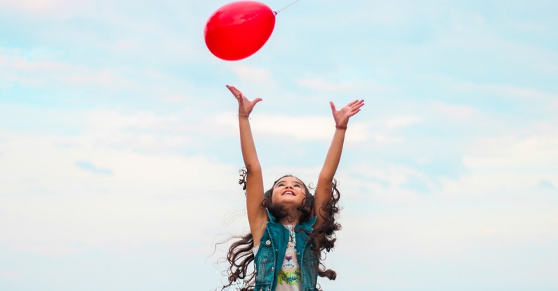 little girl tossing balloon in air, bible verses self-care