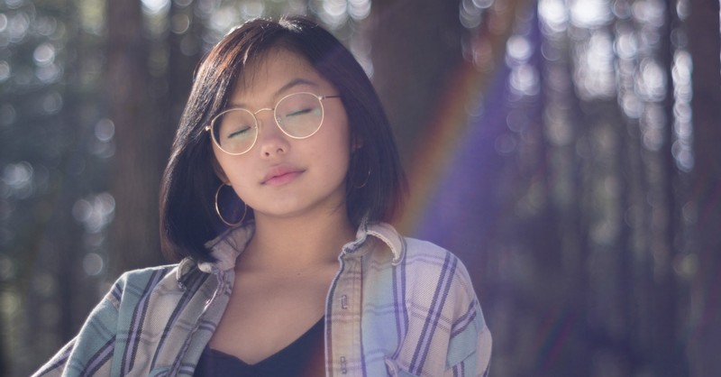 woman with eyes closed meditating, bible verses self-care