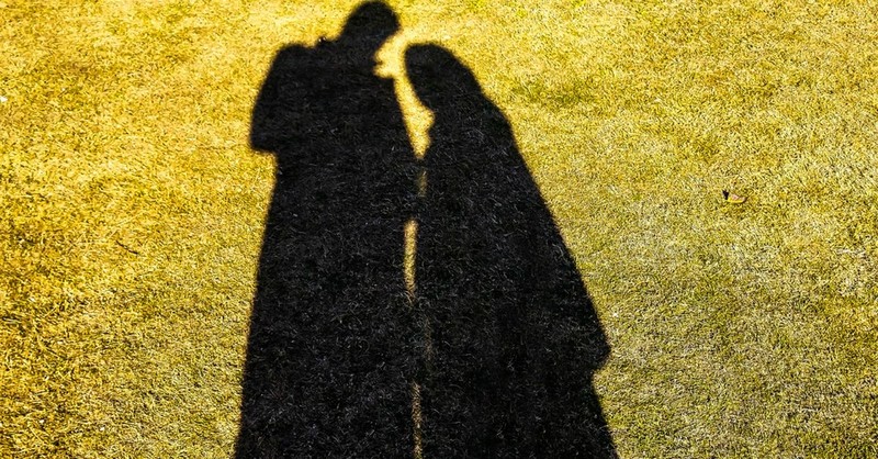 shadow of couple standing close to each other