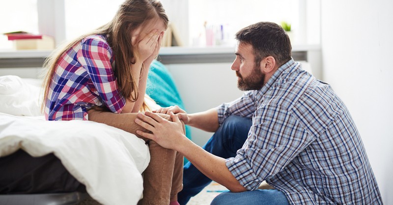 dad talking to daughter looking upset, fears harm child's faith