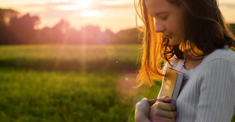 girl hugging bible