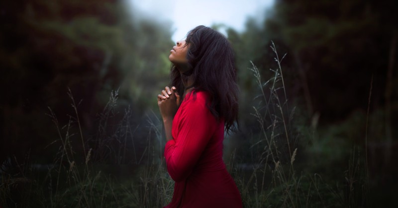 woman praying in field, never miss what god is doing in your life