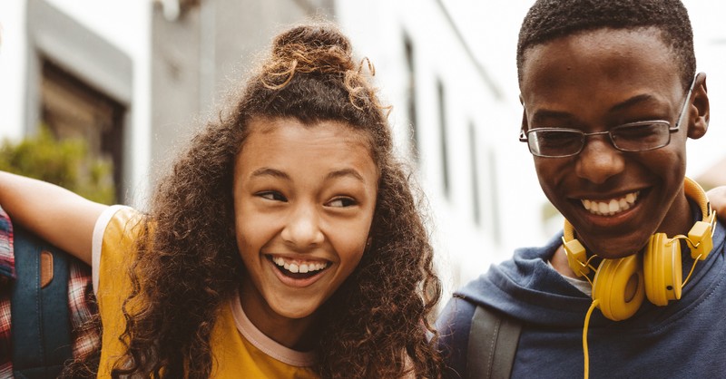 tween boy and girl laughing together