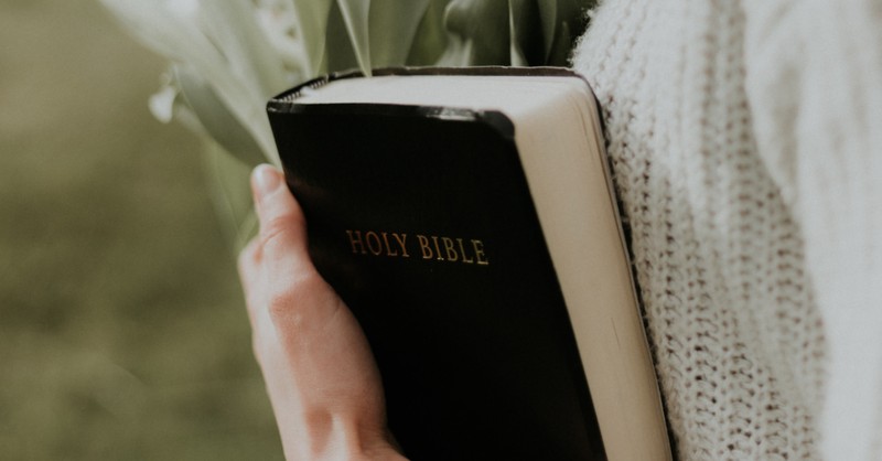 Closeup of a woman holding a Bible