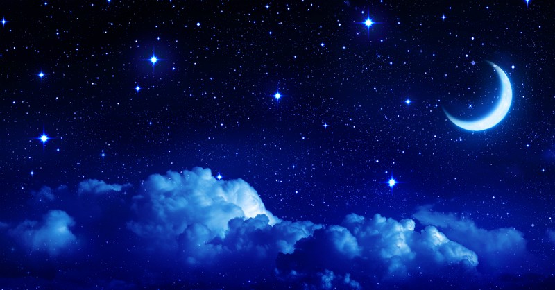 dark blue night sky with clouds stars and crescent moon