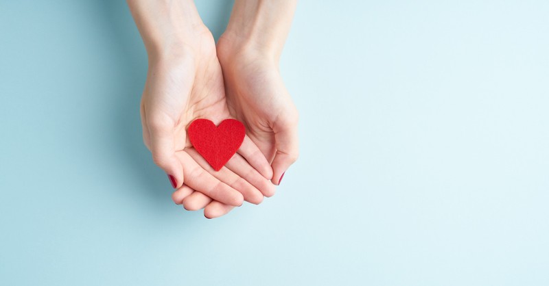 Small felt heart in someone's hands