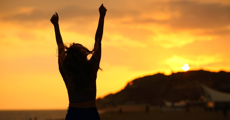 Woman hands up in victory