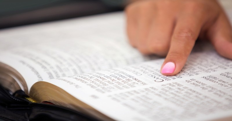 Close up of a lady reading Bible, leave and cleave