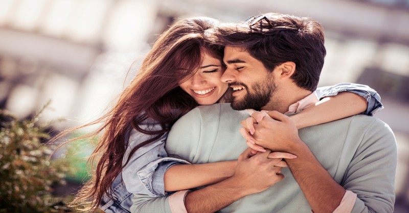 Happy young couple having fun outdoors and smiling, leave and cleave