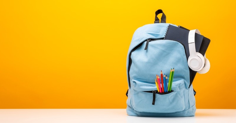backpack with school supplies yellow background, christian parents education
