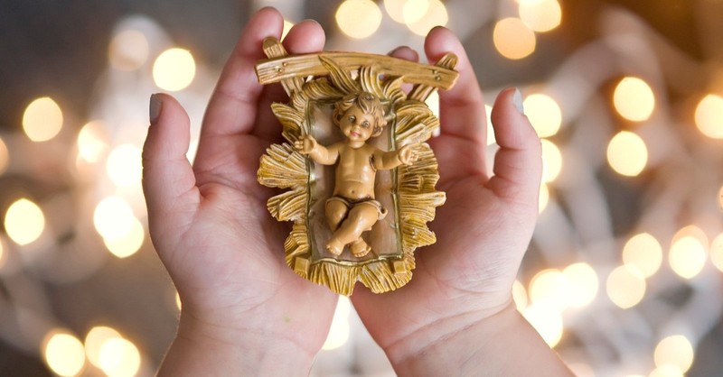 child hands holding a baby jesus nativity statue, the burning babe robert southwell christmas poems