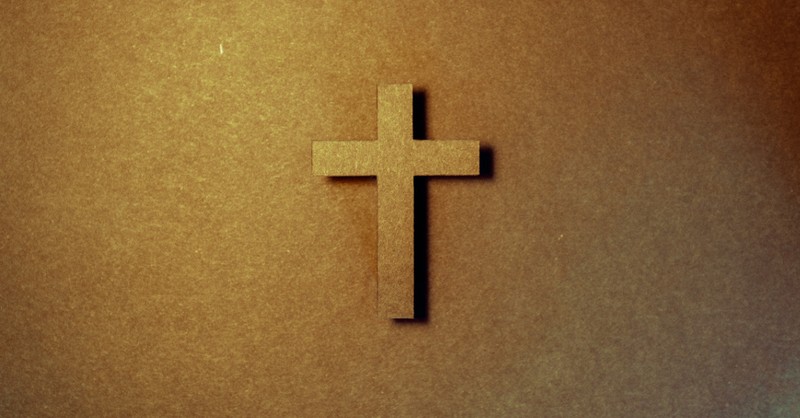 A cross on a wooden background