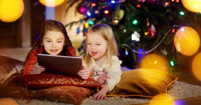 two little girls looking at an iPad, 7 best family movies streaming in December